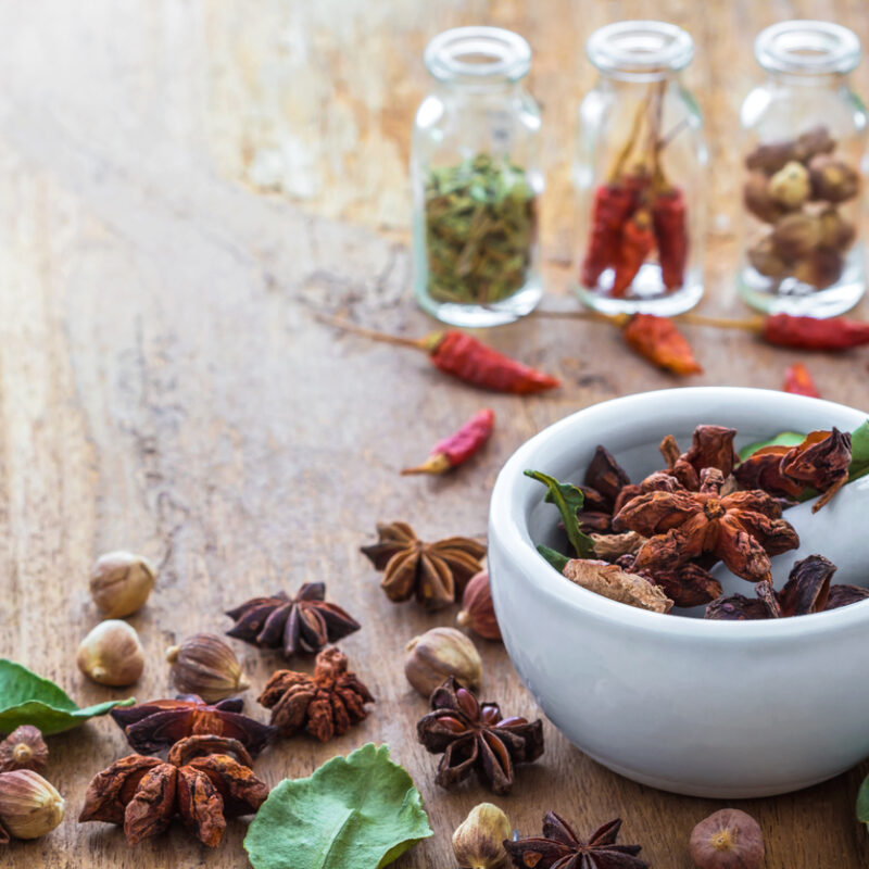 A photo of Mortar Grinder Herb and herbal medicine on wood table, Selective focus, Soft focus